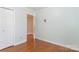 Simple bedroom with hardwood floors and open door at 1315 Shady Bluff Dr, Charlotte, NC 28211