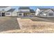 View of homes from a sloped backyard with dry grass at 148 Windy Dell Dr, Tega Cay, SC 29708
