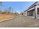 Backyard with a patio, grassy area, and sloped terrain at 148 Windy Dell Dr, Tega Cay, SC 29708
