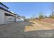 Spacious backyard with ample grassy area and sloped terrain at 148 Windy Dell Dr, Tega Cay, SC 29708