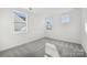 Bedroom with grey carpet and two windows with natural light at 148 Windy Dell Dr, Tega Cay, SC 29708