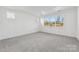 Bright bedroom with grey carpet and large window providing natural light at 148 Windy Dell Dr, Tega Cay, SC 29708