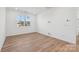 Spacious bedroom with large window and light wood floors at 148 Windy Dell Dr, Tega Cay, SC 29708