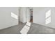 Grey carpeted bedroom with sunlight and doors to bathroom at 148 Windy Dell Dr, Tega Cay, SC 29708