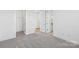 Grey carpeted bedroom with doors to closet and bathroom at 148 Windy Dell Dr, Tega Cay, SC 29708