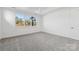 Well-lit bedroom with grey carpet and a large window at 148 Windy Dell Dr, Tega Cay, SC 29708