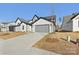 Two-story home with gray and white exterior, two-car garage, and landscaping at 148 Windy Dell Dr, Tega Cay, SC 29708