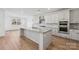 Spacious kitchen featuring a large island, granite countertops, and stainless steel appliances at 148 Windy Dell Dr, Tega Cay, SC 29708