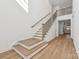 Elegant staircase with wooden railings and hardwood floors at 148 Windy Dell Dr, Tega Cay, SC 29708