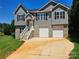 Two-story house with gray siding, stone accents, and a two-car garage at 2061 Gary Ln, Hickory, NC 28602