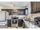 Modern kitchen with dark brown cabinets, granite countertops, and stainless steel appliances at 213 Morton St, Shelby, NC 28152