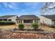 Home's backyard showcasing patio and surrounding landscape at 2481 Bergamot St, Tega Cay, SC 29708