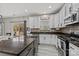 Modern kitchen with white cabinets, granite countertops, and stainless steel appliances at 3032 Sterling Ct, Indian Land, SC 29707