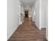 Long hallway with wood-look flooring leading to living spaces at 3233 Whispering Creek Dr # 091, Indian Trail, NC 28079