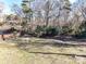 Wooded backyard with sloped lawn and trees at 3416 Olde Creek Trl, Matthews, NC 28105