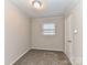 Well-lit bedroom with wood paneling, carpet, and window at 3416 Olde Creek Trl, Matthews, NC 28105