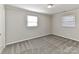 Well-lit bedroom featuring carpet and two windows at 3416 Olde Creek Trl, Matthews, NC 28105