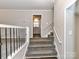 Gray carpeting on staircase leading to kitchen and living spaces at 3416 Olde Creek Trl, Matthews, NC 28105