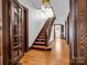 Grand staircase with wood railing and dark wood doors at 407 N Grove St, Lincolnton, NC 28092