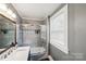 Clean bathroom featuring a tub shower combo and updated vanity at 415 Willow St, Gastonia, NC 28054