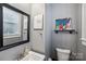 Small half bathroom with a sink, toilet, and framed art at 415 Willow St, Gastonia, NC 28054