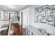 Upper hallway with hardwood floors and neutral walls at 415 Willow St, Gastonia, NC 28054