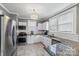 Modern kitchen with white cabinets, granite counters, and stainless steel appliances at 415 Willow St, Gastonia, NC 28054