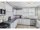 Updated kitchen featuring white cabinets, granite countertops, and stainless steel appliances at 415 Willow St, Gastonia, NC 28054