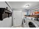 Laundry room with washer, dryer, and wooden shelf at 415 Willow St, Gastonia, NC 28054