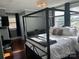 Main bedroom with four-poster bed and gray walls at 415 S Willow St, Gastonia, NC 28034