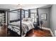 Main bedroom with a four-poster bed and hardwood floors at 415 Willow St, Gastonia, NC 28054