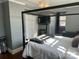 Main bedroom with four-poster bed and gray walls at 415 Willow St, Gastonia, NC 28054