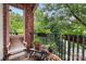 Relaxing balcony with brick columns, potted plants, and wooden chairs at 416 Queens Rd # 11, Charlotte, NC 28207