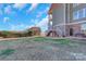Landscaped backyard with shed and lake view at 49412 Wood Land Dr, Norwood, NC 28128