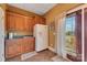 Basement kitchenette with refrigerator, sink, and cabinets at 49412 Wood Land Dr, Norwood, NC 28128