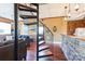 Basement with spiral staircase, stone accent wall, and living area at 49412 Wood Land Dr, Norwood, NC 28128
