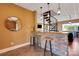 Basement wet bar with stone countertop and two bar stools at 49412 Wood Land Dr, Norwood, NC 28128