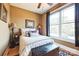 Cozy bedroom with neutral bedding and a large window offering natural light at 49412 Wood Land Dr, Norwood, NC 28128