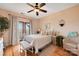 Bedroom with lake view, sliding doors to deck, and a ceiling fan at 49412 Wood Land Dr, Norwood, NC 28128