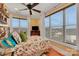 Bright bedroom with floral bedding, large windows, and a ceiling fan at 49412 Wood Land Dr, Norwood, NC 28128