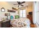 Cozy bedroom with a floral comforter and rustic wood shelves at 49412 Wood Land Dr, Norwood, NC 28128