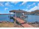 Lakefront property with a boathouse and a wooden walkway at 49412 Wood Land Dr, Norwood, NC 28128