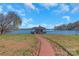 Lakefront property with a boathouse and wooden walkway at 49412 Wood Land Dr, Norwood, NC 28128