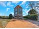 Three-story home with stone and siding accents, and a spacious driveway at 49412 Wood Land Dr, Norwood, NC 28128