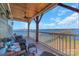 Relaxing lakefront view from a spacious deck with comfortable seating at 49412 Wood Land Dr, Norwood, NC 28128