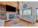 Spacious living room with stone fireplace, built-ins, and lake views at 49412 Wood Land Dr, Norwood, NC 28128