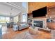 Open-concept living area with a cozy fireplace and built-in shelving at 49412 Wood Land Dr, Norwood, NC 28128