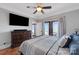 Main bedroom with king bed, large TV, and access to balcony at 49412 Wood Land Dr, Norwood, NC 28128