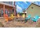 Relaxing patio area with fire pit and colorful Adirondack chairs at 49412 Wood Land Dr, Norwood, NC 28128