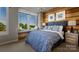 Bright bedroom with a king-size bed, wood-paneled accent wall, and window seat at 5023 Layman Dr # 25, Charlotte, NC 28226